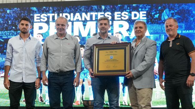 Guillermo De Rivas encabezó el acto de reconocimiento a Estudiantes de Río Cuarto por el ascenso al fútbol grande de AFA. Agustín Calleri hace entrega de una placa conmemorativa de la Provincia, y la recibe Alicio Dagatti. Juan Manuel Llamosas no estuvo presente por motivos de agenda; tampoco Martín LLaryora. 