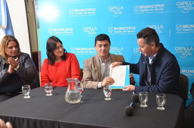 Manuel Calvo, ministro de Gobierno de Martín Llaryora, entrega fondos junto a Mariana Caserio, a Fabricio Díaz, intendente de Capilla del Monte.